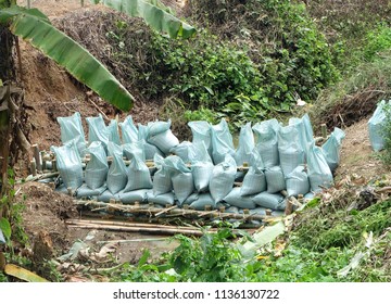 Close Up Of A Rope Bamboo  Structure And Sandbag. For Security In Constructing Small  Water Reservoir Of The People Of Northern Thailand.