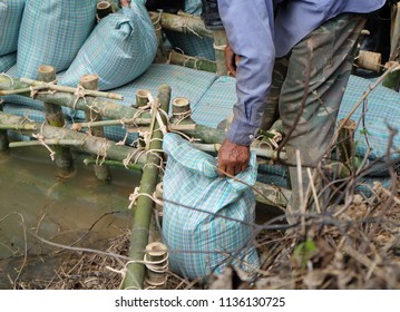 Close Up Of A Rope Bamboo  Structure And Sandbag. For Security In Constructing Small  Water Reservoir Of The People Of Northern Thailand.