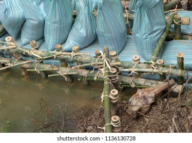 Close Up Of A Rope Bamboo  Structure And Sandbag. For Security In Constructing Small  Water Reservoir Of The People Of Northern Thailand.