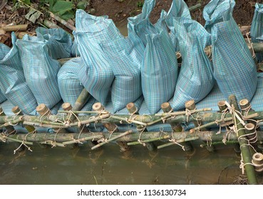 Close Up Of A Rope Bamboo  Structure And Sandbag. For Security In Constructing Small  Water Reservoir Of The People Of Northern Thailand.