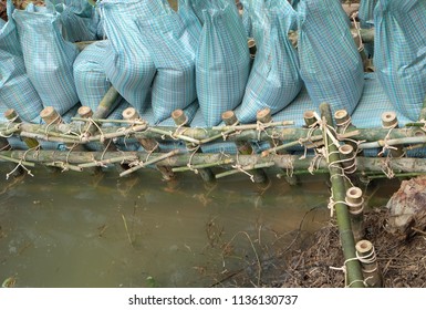 Close Up Of A Rope Bamboo  Structure And Sandbag. For Security In Constructing Small  Water Reservoir Of The People Of Northern Thailand.