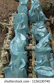 Close Up Of A Rope Bamboo  Structure And Sandbag. For Security In Constructing Small  Water Reservoir Of The People Of Northern Thailand.