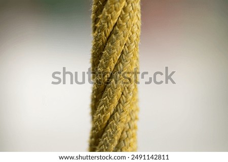 close up rope single thread macro photography fabric material yellow color object on neutral blurred background with empty space template concept picture