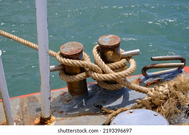 Close up of ropes and rusty bollard. rope and Marina bollard on moorage. Nautical mooring rope. The concept of mooring and water transportation