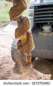 Close Up Of The Rotating Blades Of A Mechanical Auger Digging Post Holes