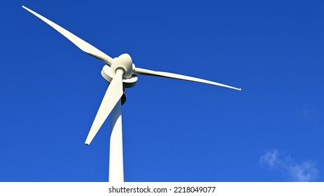 Close Up Of Rotor Blades On A Wind Turbine In The Sunshine Against A Clear Blue Sky