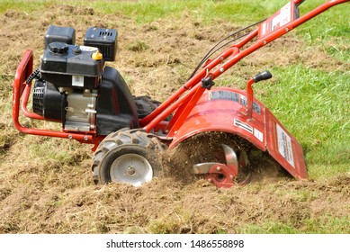 Close Up Of A Rototiller Digging Into Soil