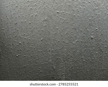 Close up of rough painted wall surface with small bumpy dotted texture  