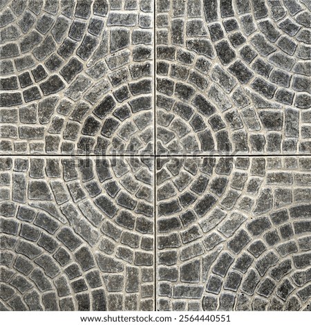 Close up of round circle shape paving stone in black and grey color. Random cut molded paving stone forming circular pattern cut in square tiles. Seamless stone tiles background texture.