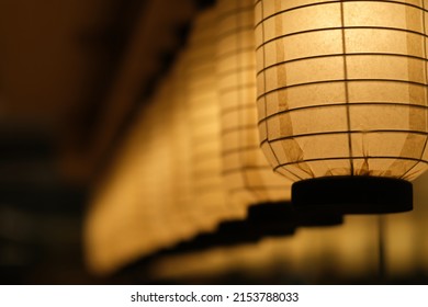 Close Up A Row Of Traditional Japanese Paper Lanterns In Diminishing Perspective At Night