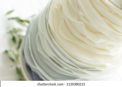 Close Up Of Ruffle Wedding Cake and Grey Ombre Gradient  