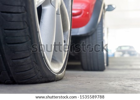 Close up of Run flat tires While there is air tire pressure lose in driving on street background.