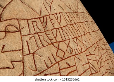 Close up of a rune stone the rökstenen in Sweden red runes