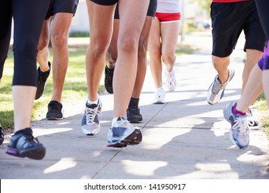 Close Up Of Runners Feet On Suburban Street