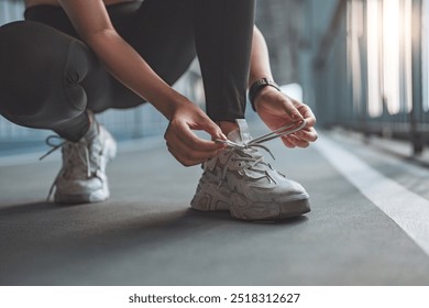 Close up - Running shoes runner woman tying laces sneakers for summer run in the city. Jogging girl exercise motivation health and fitness exercise, lifestyle. - Powered by Shutterstock