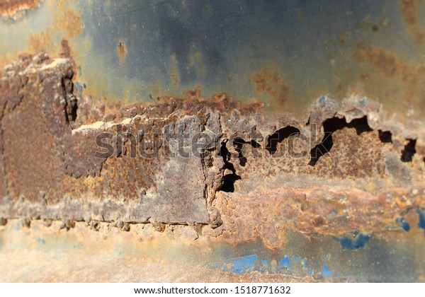 Close up of rust damage to metal surface. Photo\
shows corrosion concept.