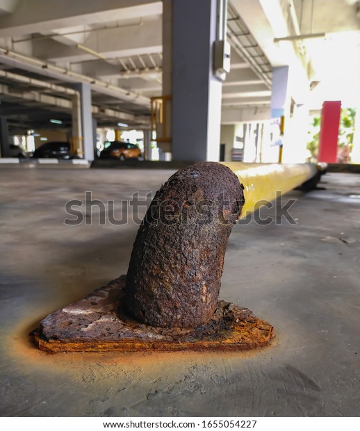 Close up  rust metal pipe old on the floor in\
car park background