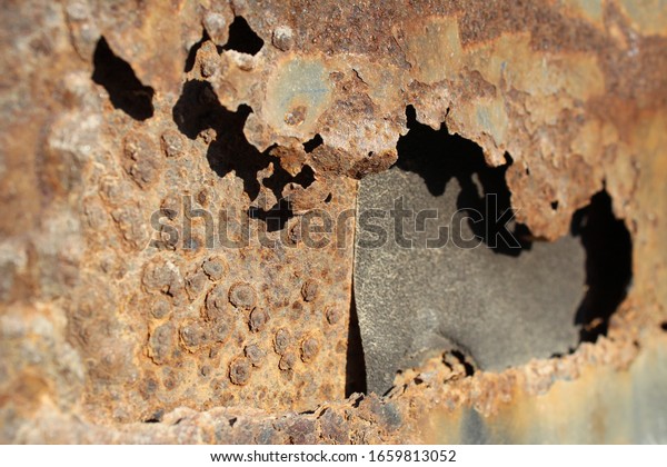 Close up of rust on a vehicle. Photo shows metal\
oxidation concept.