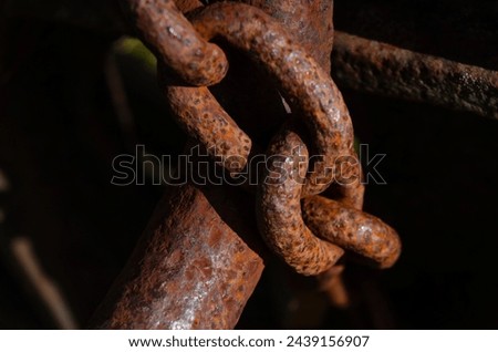 Close up of a rusted chain securing an old machine for safety reasons