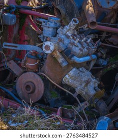 Close up of rusty car engine and interior parts, showing corrosion, decay and mechanical details in an abandoned vehicle.