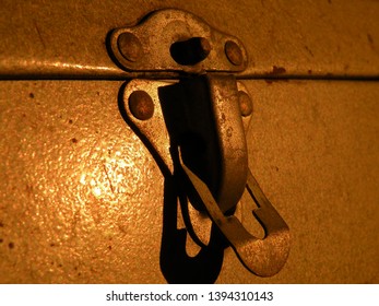 Close Up Of A Rusty Latch, On A Vintage Metal Fishing Or Tackle Box, In Natural Lighting.