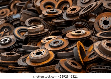 close up of rusty old car rotors at scrap yard