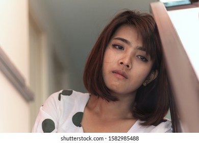 Close Up Sad Asia Woman Sitting At Stairwell Fire Escape.Depression And Problem Concept.