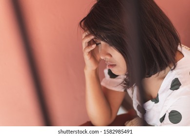 Close Up Sad Asia Woman Sitting At Stairwell Fire Escape.Depression And Problem Concept.