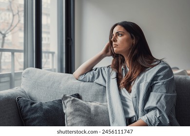 Close up of sad pensive millennial woman sit alone thinking about relationships personal problems, upset thoughtful young female lost in thoughts feel lonely depressed pondering or mourning at home - Powered by Shutterstock