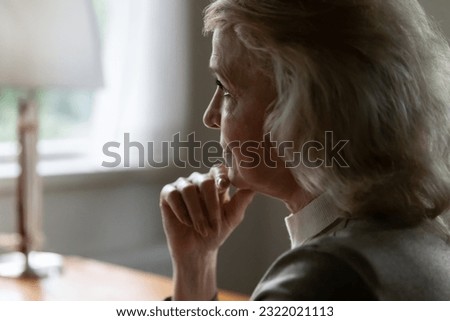 Close up of sad upset old Caucasian woman look in distance feeling lonely lack communication and care. Unhappy pensive mature female suffer from loneliness solitude, ponder of retirement maturity.