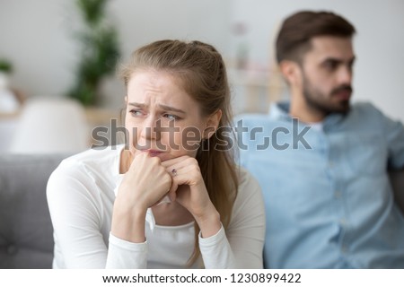 Close up of sad woman cry after fight with husband, unhappy young wife feel lonely having disagreement with spouse, upset female look in distance thinking of relationships problems or breakup