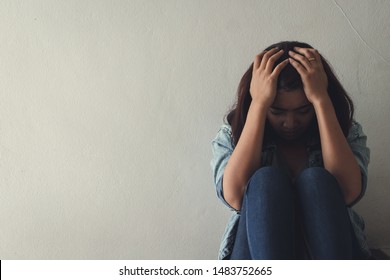 Close Up Sad Woman Sitting At Staircase In Apartment.Sad,depression Concept. 