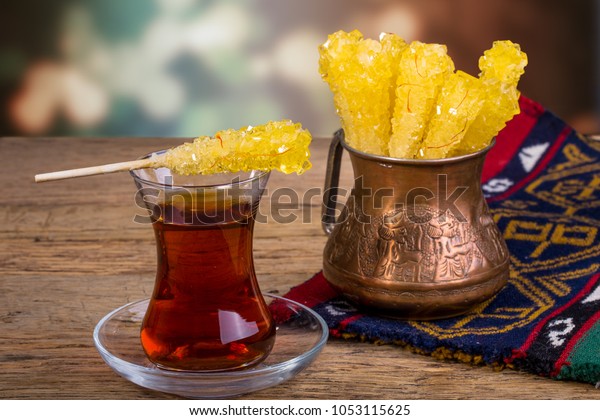 Close Up Of Saffron Rock Candy Sugar Crystal On A\
Black Tea Cup Is Often Used To Be Dissolved In Tea In Iranian\
Persian Cuisine