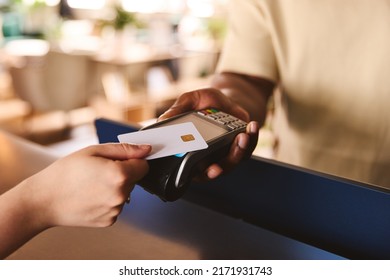 Close In Of Sales Assistant In Retail Shop With Customer Paying Using Contactless Payment Credit Card NFC - Shutterstock ID 2171931743