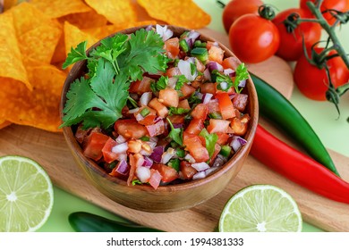 Close Up Of Salsa Roja Traditional Mexican Sauce With Ingredients For Making On A Light Green Background. Homemade Recipe Pico De Gallo With Nachos. 