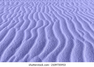 Close up of sand pattern of a vertical dunes. Macro sand. 2022 trending PANTONE 17-3938 Very Peri color