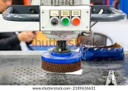 close up sanding paper flap wheel or abrasive disc of deburring polishing machine for dust or rust remove of metal sheet or steel plate in industrial