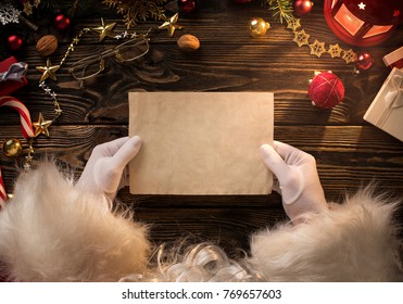 Close Up Of Santa Claus Hands Holding, Reading Blank Letter With Copy Space