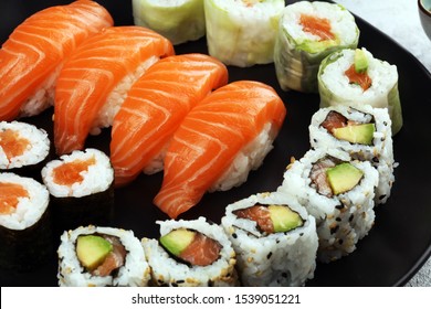 close up of sashimi sushi set with chopsticks and soy - sushi roll with salmon and sushi roll with smoked eel, selective focus. - Powered by Shutterstock