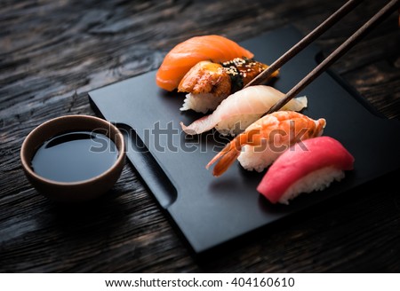 close up of sashimi sushi set with chopsticks and soy