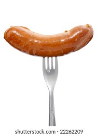 close up of sausage and fork on white background with clipping path