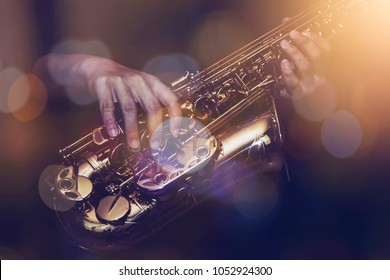 close up of saxophone player plays saxophone  with music concert light and Bokeh on stage - Shutterstock ID 1052924300
