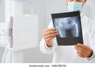 Close Up Of Scan With Image Of Pelvis And Hip Bone In Doctors Hands After Ultrasound Diagnostic . Radiologist Learning Image After Procedure Of Ultra Sonography In Cabinet Of Modern Clinic.