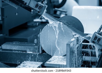 Close up scene the band saw machine cutting the metal rod with water base cooling method. The machine tool for industrial purpose. - Powered by Shutterstock