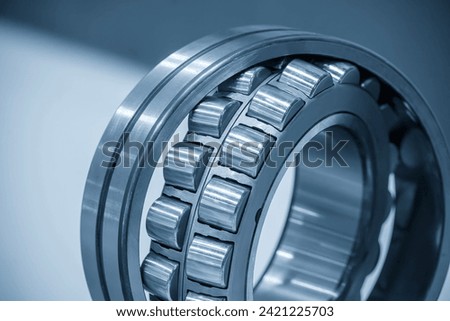 Close up scene the disassembly spherical roller bearing parts in the light blue scene. The heavy mechanical part manufacturing concept.