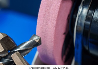 Close up scene the drill tool regrinding process with abrasive stone wheel. The tool regrinding process for CNC milling machine. - Powered by Shutterstock