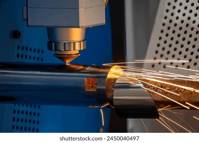 Close up scene the fiber laser cutting machine cut the stainless steel tube and sparkling light. The hi-technology sheet metal manufacturing process by laser cutting machine.  - Powered by Shutterstock