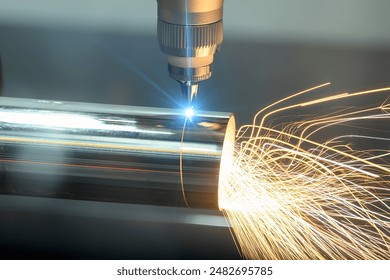 Close up scene the fiber laser cutting machine cut the stainless steel tube with sparkling light. The hi-technology sheet metal manufacturing process by laser cutting machine. 