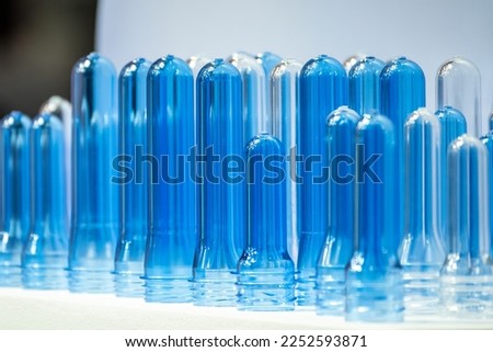 Close up scene of group of preform shape of PET bottle products. The raw material for plastic bottle manufacturing process.