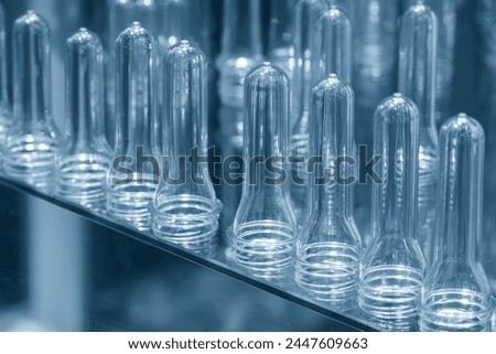Close up scene of group of preform shape of PET bottle products. The raw material for plastic bottle manufacturing process. Stock photo © 